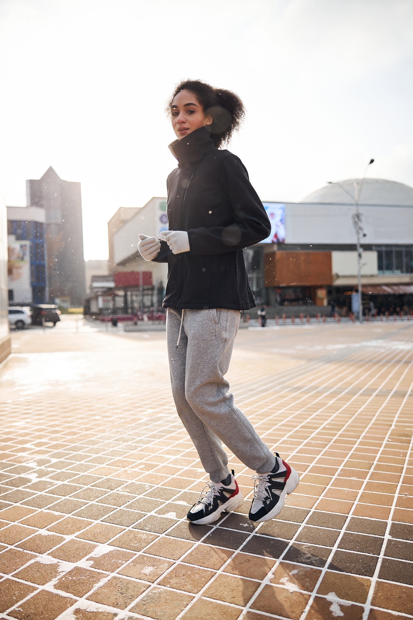 Bothered female jogging leisurely through the central area